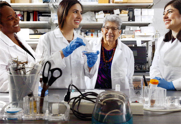 Elma Gonzalez, 65, Ph.D. with TWU graduate students in the lab.